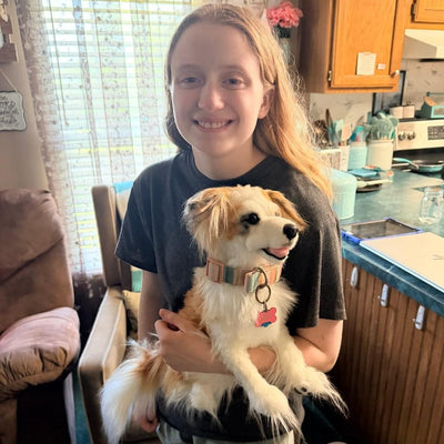 Customer in her kitchen with the stuffed animal replica of her tan and white dog