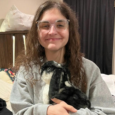 Customer holding the stuffed animal made to look like her black and white cat