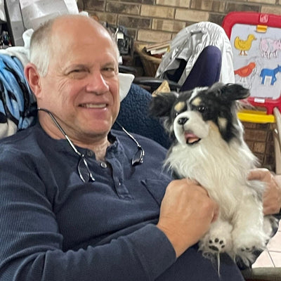 Customer holding the stuffed animal that looks like her black and white dog