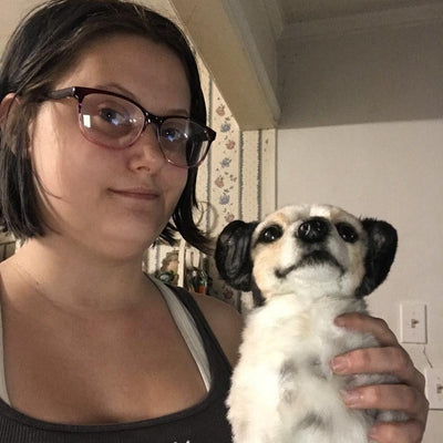 Customer holding the custom stuffed animal made to look like her spotted dog