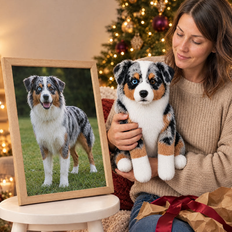 Custom stuffed animal of your pet held in both arms beside the framed photo it was made from, by a Christmas tree